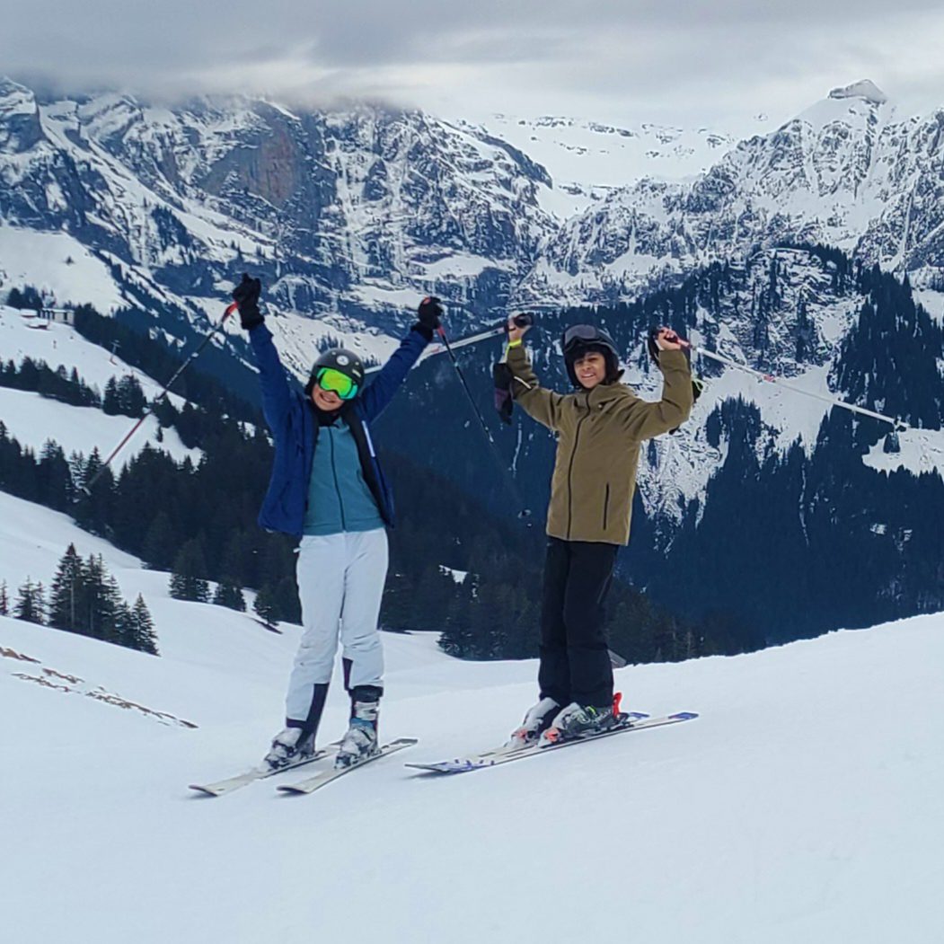 Two teens on a ski slope